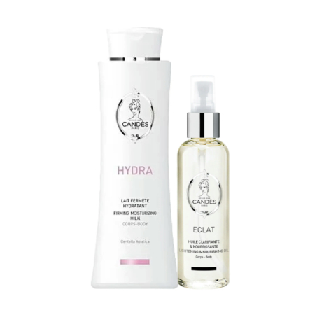 Deux produits cosmétiques sont présentés sur fond blanc : un grand flacon blanc étiqueté « Hydra, Lait Hydratant Raffermissant » et un flacon transparent muni d'une pompe étiqueté « Éclat, Huile Nourrissante Éclaircissante ». Tous deux arborent le logo Candes. Dakar