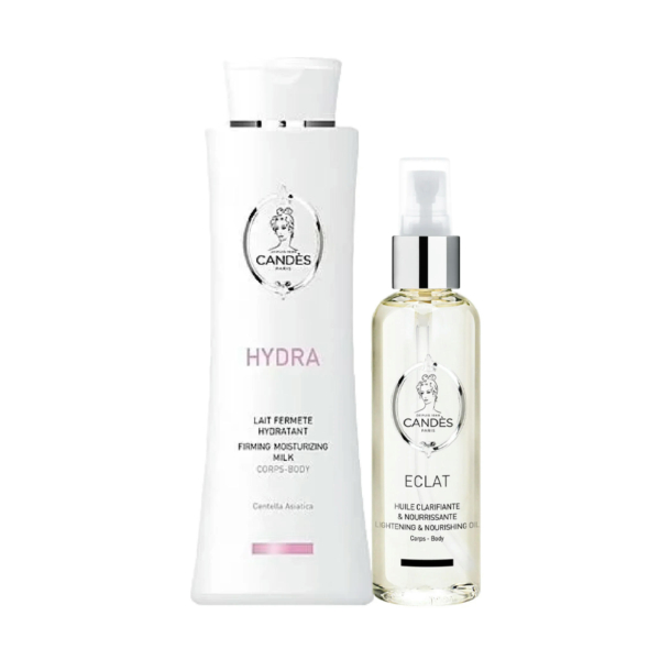 Deux produits cosmétiques sont présentés sur fond blanc : un grand flacon blanc étiqueté « Hydra, Lait Hydratant Raffermissant » et un flacon transparent muni d'une pompe étiqueté « Éclat, Huile Nourrissante Éclaircissante ». Tous deux arborent le logo Candes. Dakar