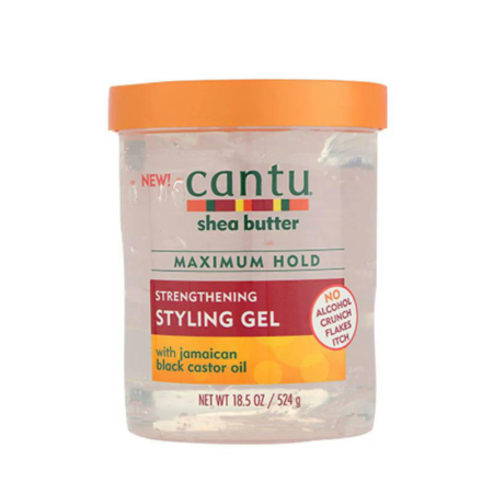 Un pot de 524 g de gel coiffant fortifiant au beurre de karité Cantu à l'huile de ricin noire de Jamaïque. L'emballage est transparent avec un couvercle orange et les informations produit sont en vert et rouge. Dakar