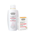 Une bouteille blanche de Lait de Beauté Château Rouge aux touches d'orange, à côté d'une boîte assortie de Savon Exfoliant. Les deux sont étiquetés avec de la vitamine C et portent un texte en français et en anglais, mettant l'accent sur l'hydratation et l'éclat. Dakar