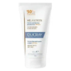 Tube blanc de crème Ducray Melascreen, avec SPF 50+. L'étiquette indique qu'il s'agit d'une crème protectrice anti-taches, adaptée aux taches brunes et aux peaux sèches. Le tube contient 50 ml. Dakar