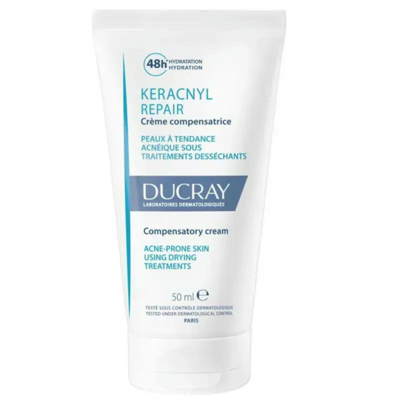 Tube blanc de Crème Compensatoire Réparatrice Keracnyl de Ducray, 50 ml. L'étiquette indique qu'elle est destinée aux peaux à tendance acnéique suivant des traitements desséchants, avec une hydratation 48 heures. Texte majoritairement en français et en anglais. Dakar