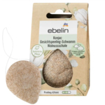L'image montre l'emballage d'une éponge exfoliante visage konjac Ebelin en coquille de noix. En forme de goutte, elle est conçue pour un soin naturel de la peau. La boîte présente un motif de cotonnier et les informations produit sont en allemand. Dakar