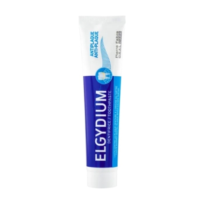 Tube de dentifrice Elgydium au design bleu et blanc, avec les inscriptions « Anti-Plaque Antiplaque » et « Dentrifrice/Toothpaste ». Le bouchon est fermé et le tube est debout. Dakar
