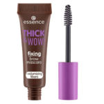 Un tube marron de mascara sourcils fixateur « Thick & Wow ! » aux fibres volumisantes d'Essence, orné d'un texte et d'un capuchon violets. La brosse, aux poils noirs, est placée à droite du tube. Dakar