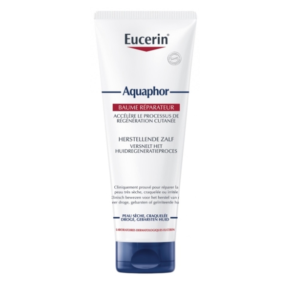 Un tube d'Eucerin Aquaphor Baume Réparateur Cutané 198 g présente un corps blanc et un bouchon bleu avec une étiquette frontale en français et en néerlandais, soulignant son pouvoir de régénération et de réparation des peaux sèches et craquelées. Dakar