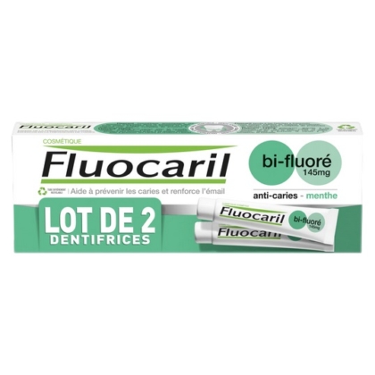 L'image montre un emballage de dentifrice Fluocaril, étiqueté « bi-fluoré 145 mg » et « anti-caries - menthe ». La boîte, de couleur verte et blanche, contient deux tubes, avec un texte en français sur les bienfaits des soins dentaires. Dakar