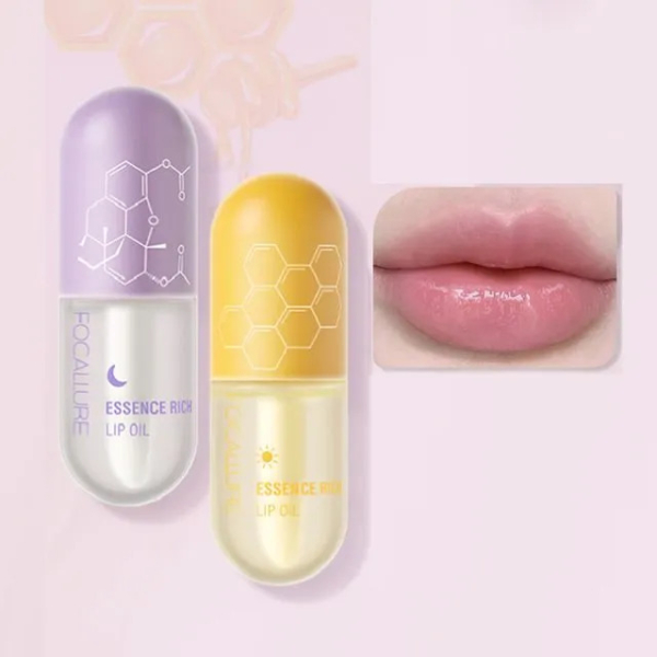 Deux flacons d'huile à lèvres en forme de capsule, l'un violet et l'autre jaune, présentent des motifs hexagonaux. À proximité, un encart présente des lèvres roses et brillantes. Le fond est d'un rose tendre. Dakar