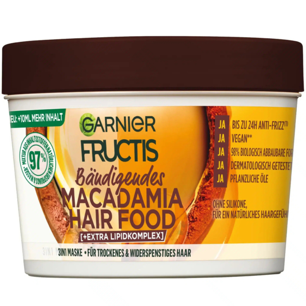 Un pot de masque capillaire Garnier Fructis Macadamia. L'emballage est principalement crème et marron avec un texte vert. Il revendique une formule vegan et des propriétés anti-frisottis, adaptée aux cheveux secs et rebelles. Dakar