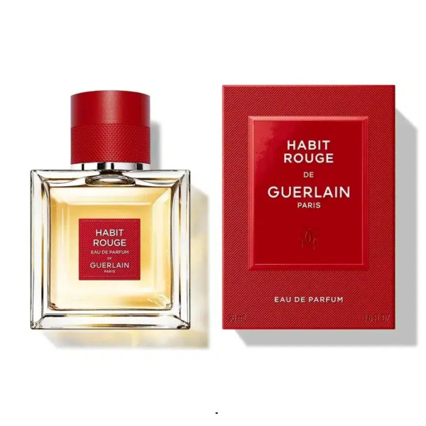 Un flacon de l'Eau de Parfum Habit Rouge de Guerlain, accompagné de son emballage rouge et or. Le flacon est carré, coiffé d'un bouchon rouge, et l'emballage arbore la même palette de couleurs, mettant en valeur le nom de la marque et du parfum. Dakar