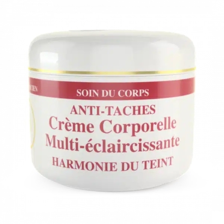 Un pot blanc de crème de soin portant l'inscription « Anti-Taches Crème Corporelle Multi-éclaircissante Harmonie du Teint » avec une bande rouge et or sur le dessus. Le texte est en français, indiquant qu'il s'agit d'une crème pour le corps harmonisant le teint. Dakar