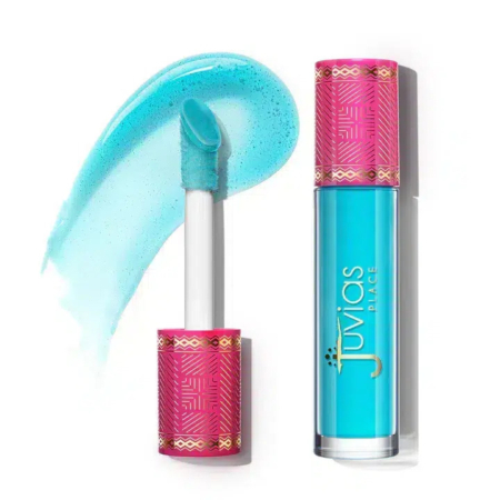Rouge à lèvres liquide bleu avec un échantillon sur fond blanc. L'emballage présente des touches de rose avec des motifs géométriques et le nom de la marque en doré. Dakar