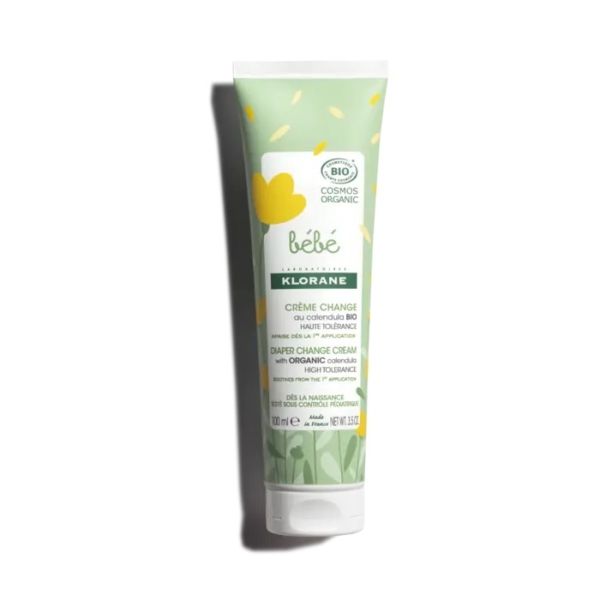 Tube de crème pour le change Klorane Bébé à l'huile d'olive bio, orné d'un motif vert et blanc avec des cœurs jaunes. Ce tube de 100 ml est étiqueté « éco-responsable » et « biologique » sur le dessus. Dakar