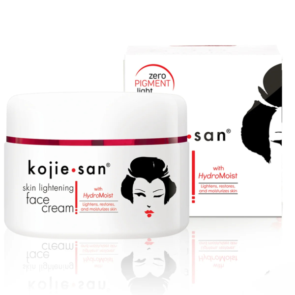 Un flacon blanc de crème éclaircissante pour le visage Kojie San est présenté devant sa boîte. Les deux produits arborent un visage de femme stylisé en noir et rouge. Le texte souligne « avec HydroMoist » et « éclaircissement sans pigment ». Dakar