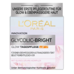 Emballage de la Crème de Jour Glycolic-Bright de L'Oréal Paris avec SPF 17 pour une peau éclatante et uniforme. Le texte en allemand met en avant l'innovation et les tests dermatologiques. La boîte présente un dégradé de rose et de blanc. Dakar