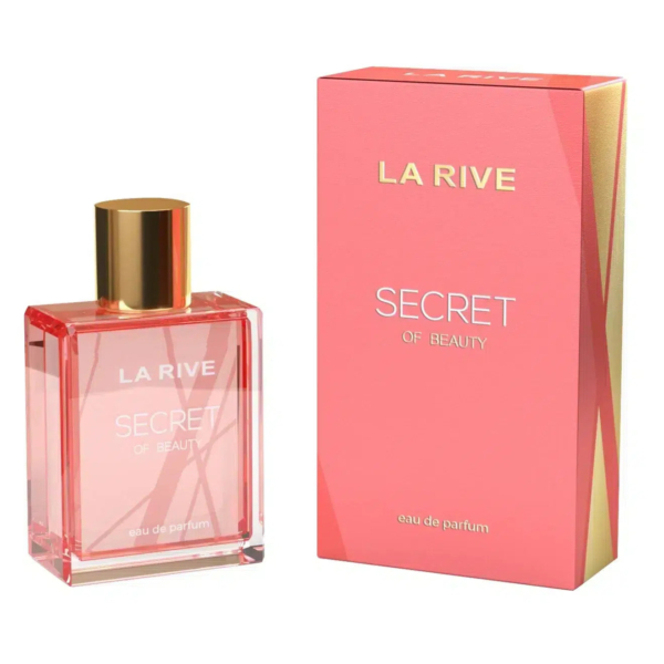 Un flacon de parfum rose et or, étiqueté « La Rive Secret de Beauté », est présenté à côté d'une boîte rose assortie aux touches dorées. La boîte porte le même texte, accompagné de la mention « eau de parfum ». Dakar