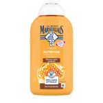 Flacon orange du shampoing Le Petit Marseillais Nutrition, avec une étiquette au miel et au beurre de karité bio. Le flacon est muni d'un bouchon à pression et est annoncé sans silicone, conçu pour les cheveux secs et cassants. L'étiquette présente les informations et les logos du produit. Dakar
