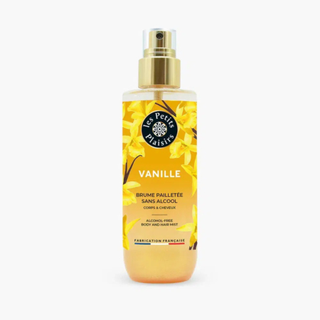 Un flacon de brume corps et cheveux parfumée à la vanille « Les Petits Plaisirs ». Le flacon est orné de fleurs de vanille jaunes et doté d'un vaporisateur doré. L'étiquette indique qu'il est sans alcool et fabriqué en France. Dakar
