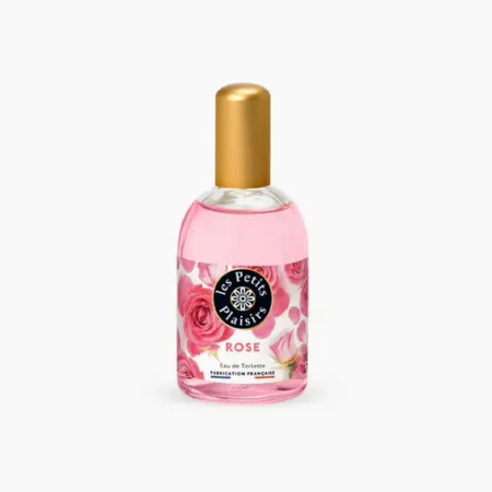 Un flacon de parfum transparent au bouchon doré, contenant un liquide rose. L'étiquette porte l'inscription « Les Petits Plaisirs Rose Eau de Toilette », avec des images de roses roses. Dakar