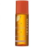 Un flacon d'huile corporelle botanique extrême Makari aux huiles d'argan et de carotte, avec un bouchon et une étiquette orange. Ce produit est formulé pour une hydratation intense et un éclat sublimé. Dakar