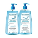 Deux flacons de Gel Douche Micellaire Dermo-Apaisant Neutraderm avec pompe bleue. Chaque flacon est étiqueté pour peaux sensibles, d'une contenance de 1 L (33,8 oz liq.), pour le visage et le corps. Dakar