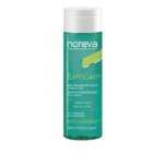 Un flacon de gel moussant doux Noreva Exfoliac pour le visage et le corps, 200 ml. L'étiquette est bleu sarcelle avec un texte blanc et jaune. Elle comporte des informations sur les soins, telles que « non comédogène » et « fabriqué en France ». Dakar