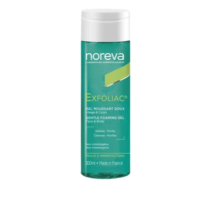 Un flacon de gel moussant doux Noreva Exfoliac pour le visage et le corps, 200 ml. L'étiquette est bleu sarcelle avec un texte blanc et jaune. Elle comporte des informations sur les soins, telles que « non comédogène » et « fabriqué en France ». Dakar