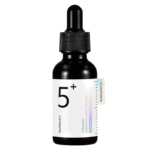 Un flacon noir avec un bouchon compte-gouttes contenant le sérum concentré vitaminé Numbuzin n° 5. L'étiquette est blanche avec un texte et des éléments graphiques minimalistes, mettant en évidence le mot « 5+ ». Dakar