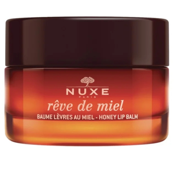 Un pot de baume à lèvres au miel Rêve de Miel de Nuxe Paris avec un couvercle marron foncé. Le contenant en verre présente une couleur ambrée dégradée et un texte blanc. Dakar