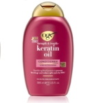 Le flacon après-shampooing OGX Keratin Oil de 385 ml, en rose et or, réduit les pointes fourchues de 80 % et prévient la casse. Dakar
