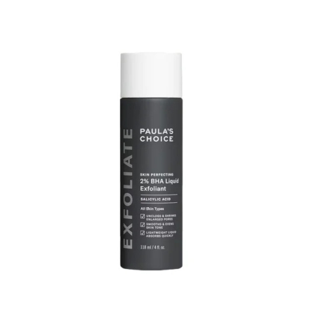 Flacon cylindrique d'exfoliant liquide Paula's Choice Skin Perfecting 2 % BHA à l'acide salicylique. L'étiquette met en avant ses bienfaits, comme le désincrustation des pores et le lissage de la peau. Le flacon est foncé avec un texte blanc. Sa contenance est de 118 ml. Dakar