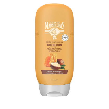 Flacon orange de l'après-shampooing Le Petit Marseillais. L'étiquette indique « Après-shampooing Nutrition, Miel de Provence et Karité Bio ». Image de nid d'abeille et de noix de karité. Conçu pour les cheveux secs et cassants. Contient 95% d'ingrédients d'origine naturelle. Dakar