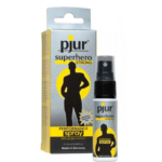 Un vaporisateur noir avec une étiquette se dresse devant son emballage gris et jaune. L'emballage présente la silhouette d'une silhouette musclée et les inscriptions « pjur superhero STRONG » et « spray performance à l'extrait de gingembre ». Dakar