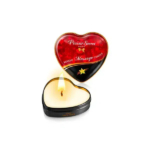 Boîte en forme de cœur avec un couvercle rouge portant l'inscription « Plaisir Secret » en blanc, contenant une bougie de massage allumée. De couleur crème, elle diffuse une douce flamme. Le couvercle est orné d'une petite fleur jaune. Dakar