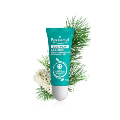 Un tube turquoise de soin anti-imperfections Puressentiel S.O.S. Skin, aux 11 huiles essentielles, se détache sur un fond de branches de pin vertes et de lichen blanc. Le tube est muni d'un bouchon à vis blanc et contient 10 ml. Dakar