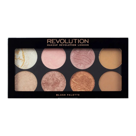 Une palette de maquillage composée de huit godets circulaires proposant différentes nuances de blush et d'enlumineur. Présentée dans un packaging noir avec l'inscription « Revolution » imprimée en doré sur le dessus. Dakar
