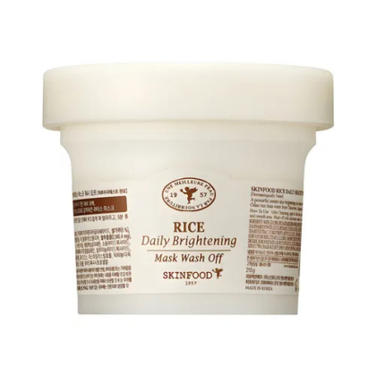Un contenant blanc de masque éclaircissant quotidien SKINFOOD au riz. L'étiquette présente des textes en anglais et en coréen, un logo marron et des éléments décoratifs. Le contenant est simple et présente une finition lisse et mate. Dakar