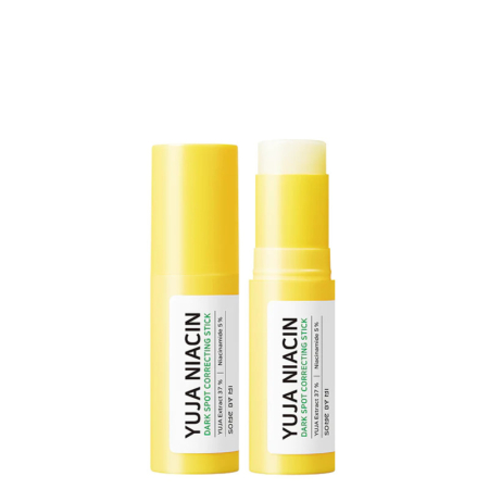 Deux sticks de soin jaunes sont présentés. L'un est fermé par un bouchon, l'autre est ouvert pour révéler le produit. Tous deux portent une étiquette blanche avec le texte noir « YUJA NIACIN Dark Spot Correcting Stick ». Dakar