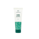 Tube de nettoyant visage purifiant à l'arbre à thé The Body Shop sur fond blanc. L'emballage est blanc et vert, avec des motifs de feuilles d'arbre à thé. Ce produit est indiqué pour les peaux à imperfections et a une contenance de 125 ml. Dakar