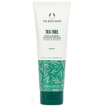 Un tube de mousse purifiante à l'arbre à thé The Body Shop. Ce tube blanc au bouchon vert est conçu pour purifier la peau et convient aux peaux à imperfections. Il contient 125 ml (4,2 fl oz US) et arbore un motif de feuilles sur le fond. Dakar