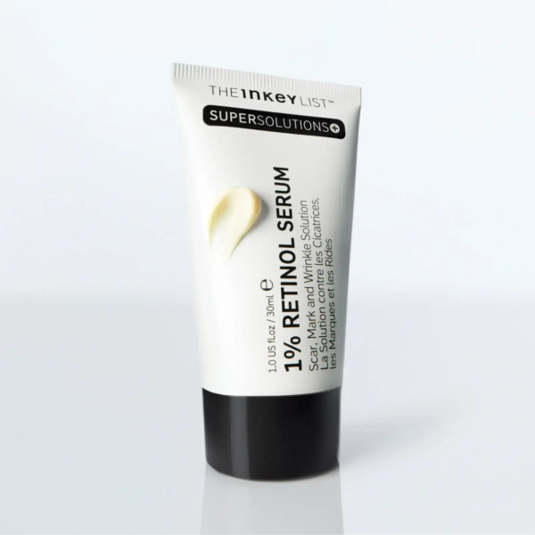 Tube blanc de sérum au rétinol 1,0 % The Inkey List Supersolutions avec bouchon noir. Le texte sur le tube souligne son utilisation pour les cicatrices, les marques et les rides. Une noisette de crème est visible sur le tube. Dakar