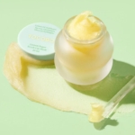 Un pot givré de Masque à Lèvres Exfoliant au Sucre et Citron Tocobo 20 ml, au design inspiré de LANEIGE, révèle une texture jaune crémeuse. Avec ses ingrédients à base de citron et d'huile d'olive, une touche de crème décore élégamment le fond vert pastel. Dakar