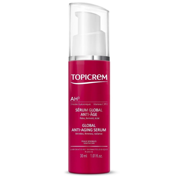 Un flacon rouge de sérum anti-âge global Topicrem avec une pompe blanche. L'étiquette mentionne des ingrédients comme l'acide hyaluronique et les vitamines C et E, et met en avant des bienfaits tels que la réduction des rides et l'éclat du teint. Contenance : 30 ml. Dakar