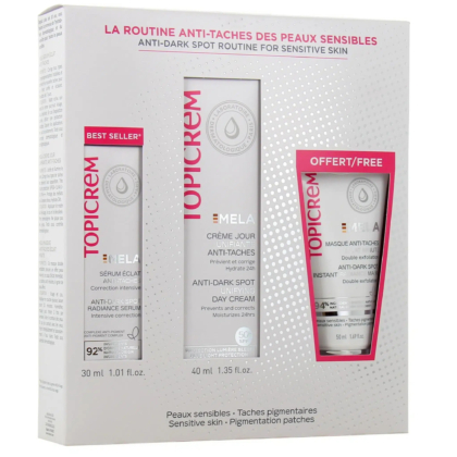 Emballage de la routine anti-taches Topicrem pour peaux sensibles, comprenant un sérum, une crème de jour et un masque. La boîte met en avant des caractéristiques comme « Meilleure vente » et une offre de produit gratuit. Couleur dominante : blanc avec des touches de rouge et des informations sur le produit. Dakar