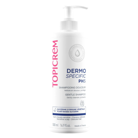 Flacon blanc de shampoing doux Topicrem Dermo Specific PH5 avec pompe. Le flacon présente les informations produit et revendique un pouvoir nettoyant et protecteur. Il est orné de lettres roses et bleues et contient 500 ml (16,9 oz liq.). Dakar