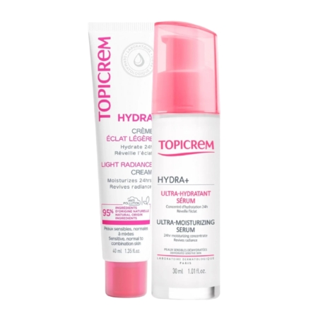Deux produits Topicrem : un tube de Crème Éclat Hydra+ Légère et un flacon de Sérum Ultra-Hydratant. Tous deux sont présentés dans un emballage rose et blanc, avec un texte soulignant l'hydratation 24 h et les ingrédients pour peaux sensibles. Dakar