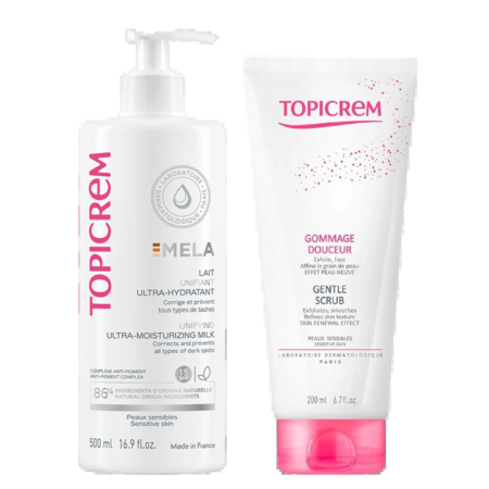 Deux produits de soin Topicrem : à gauche, le Lait Ultra-Hydratant Emla en flacon de 500 ml. À droite, le Gommage Douceur en tube de 200 ml. Les deux flacons sont blancs avec des touches de rose. Dakar