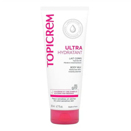 Tube blanc de Lait Corps Ultra Hydratant Topicrem avec bouchon rose, portant le logo de l'entreprise, la description du produit et les informations détaillées en français et en anglais. Conçu pour les peaux sèches et sensibles. Contient de la glycérine et de la cire d'abeille. 300 ml. Dakar