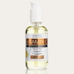Un flacon transparent de Advanced Clinicals Huile Corporelle Éclaircissante à la Vitamine C 112 ml avec une pompe blanche et une étiquette orange-blanche, contenant 3.8 fl oz (112 ml) de produit. Dakar