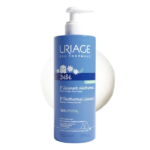 Flacon bleu de Liniment Oléothermique Uriage Bébé 1er. L'étiquette est ornée de fleurs blanches et d'un texte indiquant son utilisation pour les soins de bébé. Contient 92 % d'ingrédients d'origine naturelle, pour un volume de 500 ml. Dakar